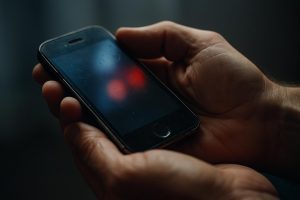 Äldre mobil hålls i händerna medan 112-samtal kan fördröjas vid 2g-3g-utfasningen